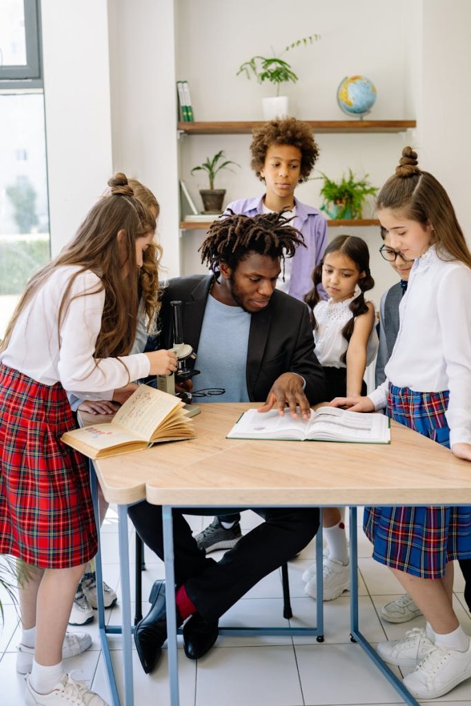 man with children leaning over desk changing families